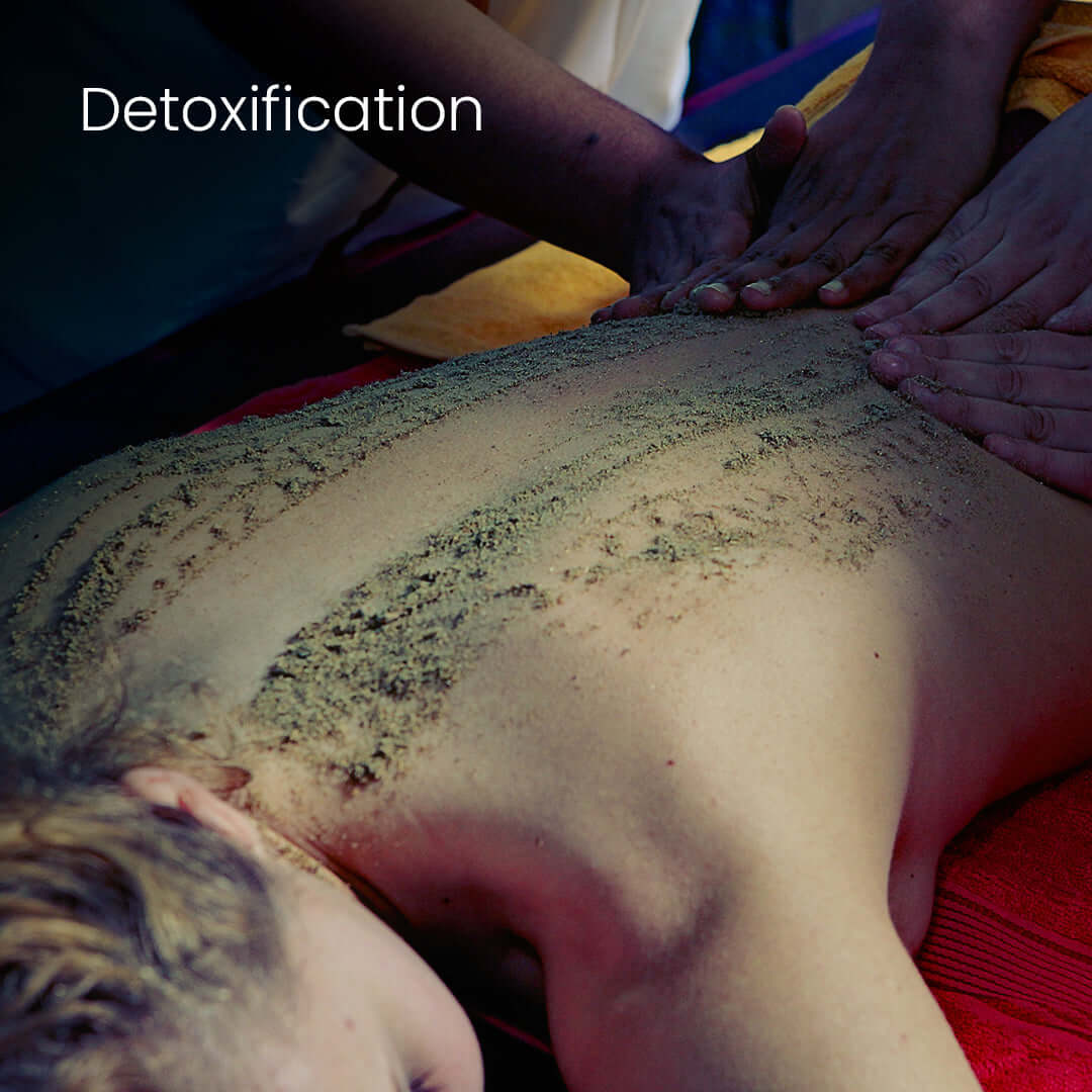 Herbal powder massage therapy as part of an Ayurveda Body Detox treatment to remove toxins and rejuvenate the skin.