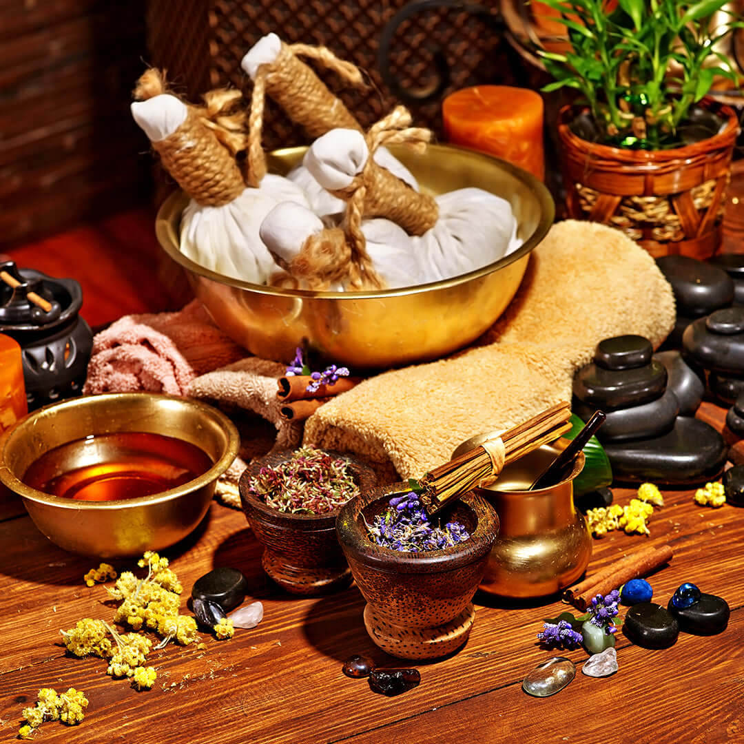 Relaxing spa setup featuring natural ingredients and tools for Ayurvedic pain relief therapy sessions.